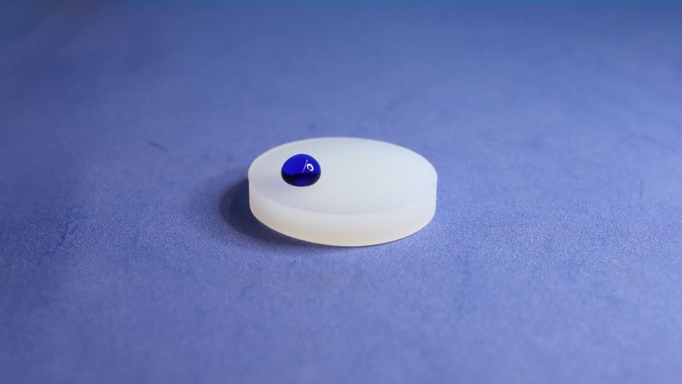 Plastic disc with blue drop