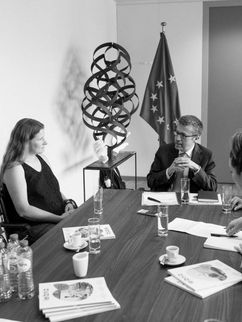 Fünf Personen im Gespräch an einem Tisch, auf dem unter anderem Leibniz-Magazine liegen. Hinter ihnen eine Europa Flagge.