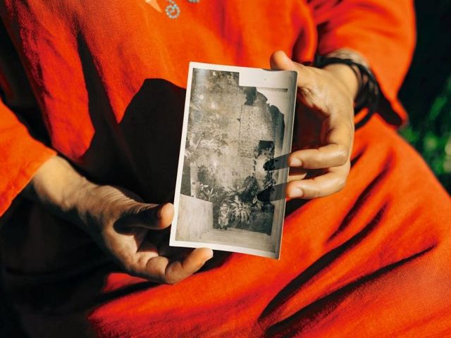 Hände, die vergilbtes Foto halten