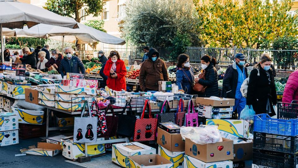 People wearing masks at an Italian market.