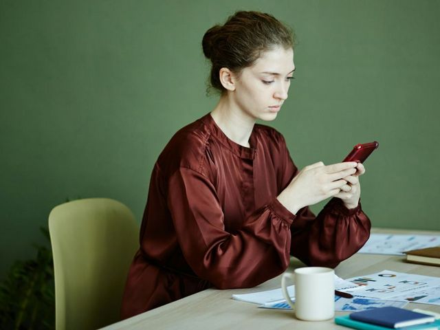 Women with a smartphone on a table