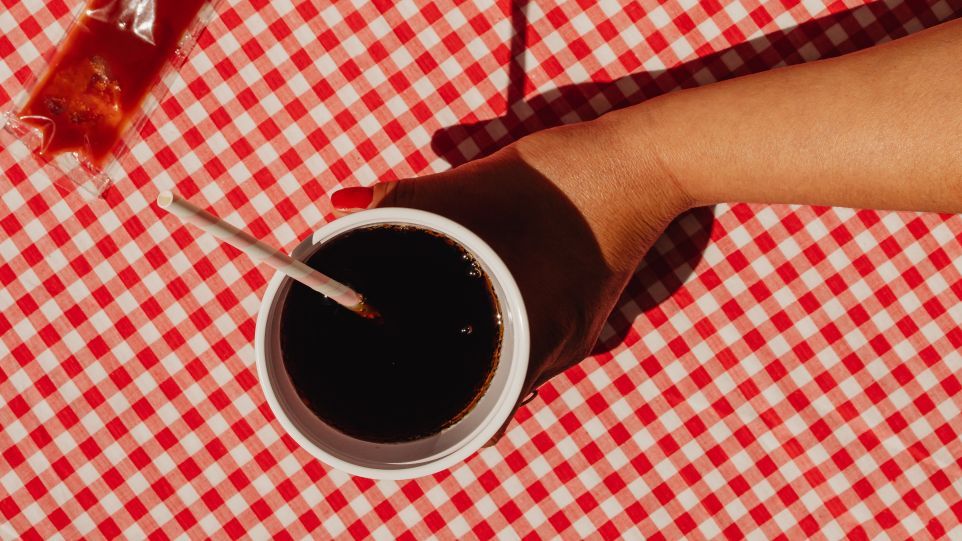 Woman's hand holding cola cup