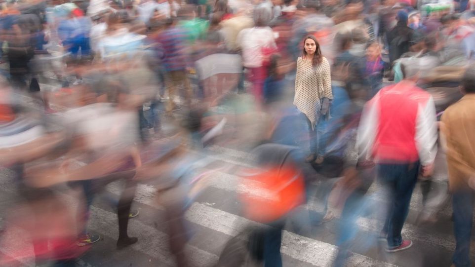 Young woman in a blurred crowd