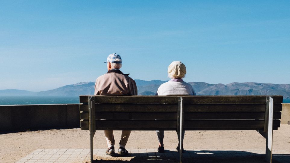 Das Bild zeigt zwei Rentner auf einer Bank.